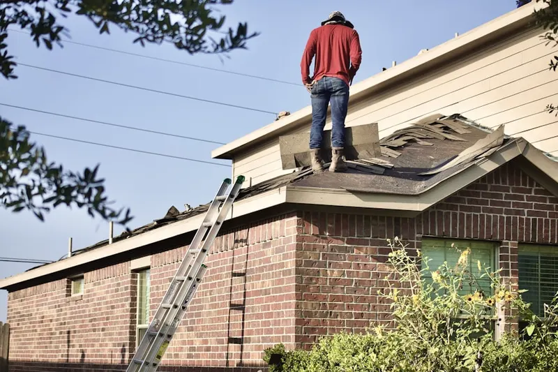 Professional roofer working on a residential roof in Saunders